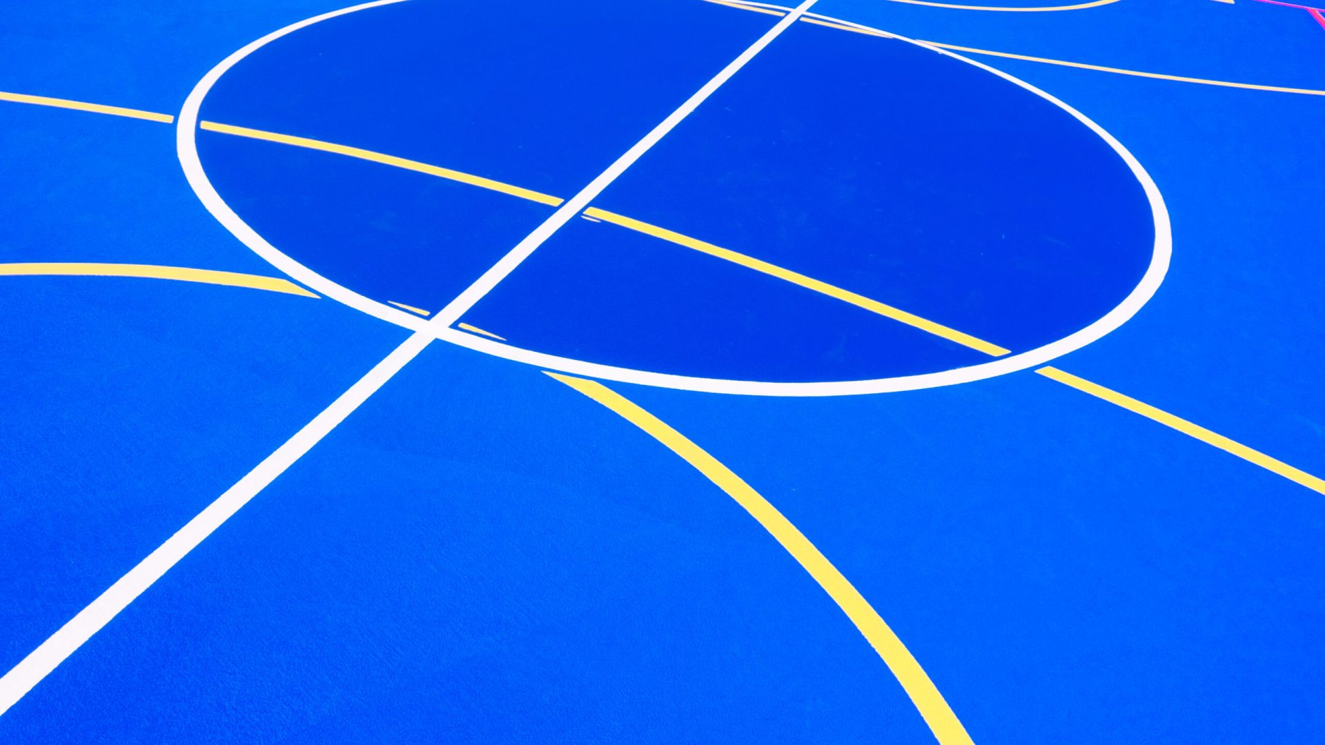 Design of a sports field, with blue background and red and yellow white lines creating strange straight lines and curves, to use with copy space.